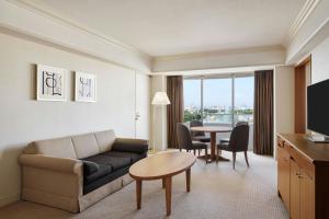 a living room with a couch and a table at Sheraton Grande Tokyo Bay Hotel in Urayasu