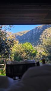 a view of a mountain through a window at Arandu Bangalô in Cavalcante +20 photos