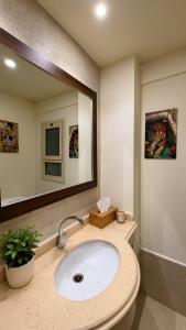 a bathroom with a sink and a mirror at 1 BDR Pool Front Cozy Apartment in Port Ghalib +16 photos