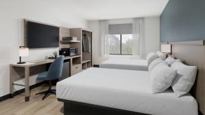 a hotel room with two beds and a desk at Hyatt Select Louisville North in Jeffersonville +6 photos