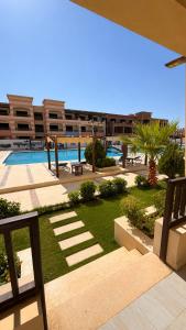 a view of a resort with a swimming pool at 1 BDR Pool Front Cozy Apartment in Port Ghalib