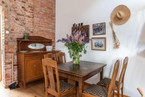 a dining room with a table with a vase of flowers on it at Villa Vimmerby in Vimmerby