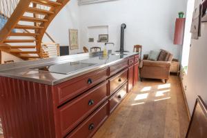a kitchen with a sink and a staircase at Villa Vimmerby in Vimmerby