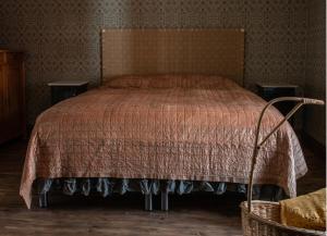 a bedroom with a bed and two night stands at Villa Vimmerby in Vimmerby