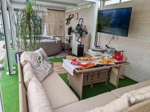 a living room with a couch and a table with food on it at Villa Shiva Cerveteri, Casa Vacanze con SPA e Idromassaggio, Relax a due passi da Roma in Cerveteri +38 photos