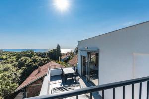 a balcony of a house with a view of the ocean at Villa & Pool in Utjeha