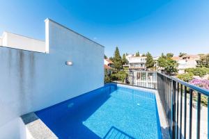 a swimming pool on the balcony of a house at Villa & Pool in Utjeha