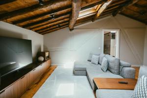 a living room with a couch and a flat screen tv at Torel Royal Court in Guimarães