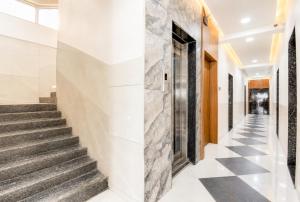 a hallway with stairs and a stone wall at Hotel The Lavendra Heritage in Patna