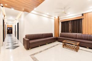 a living room with a couch and a table at Hotel The Lavendra Heritage in Patna