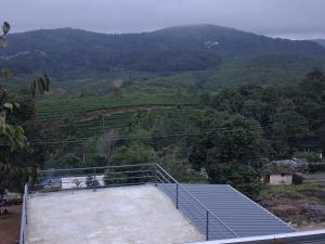a room with a view of a mountain at Venus Valley Vagamon in Vagamon +4 photos