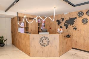 an office with a wooden wall with a world sign on it at C'est La Vie Hotel Marsascala in Marsaskala