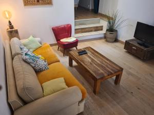 a living room with a couch and a coffee table at Le logis de la Fontaine in Ceyreste