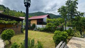 a house with a lamp post in a yard at Red Roofs in K'eda +11 photos