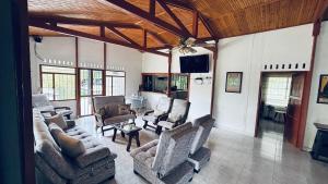 a living room with couches and chairs and a fireplace at GatoPardo in Montenegro