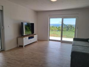 a living room with a flat screen tv and a couch at Mabora in Crikvenica
