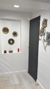 a room with three mirrors on a wall with a door at Small Space Charm in Tampa