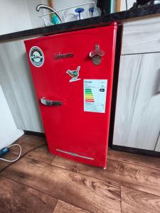 an old red refrigerator sitting in a kitchen at Rustika Tiny House in Pucón