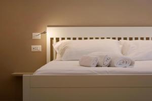 a bed with two towels sitting on top of it at Annina Locanda in Corciano
