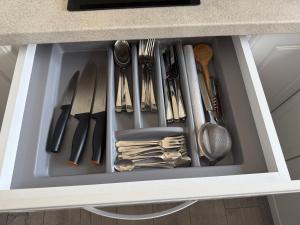 a drawer filled with utensils in a kitchen at Cely's Ap Class Park in Târgovişte