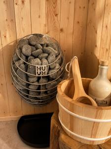 a bucket of rocks sitting next to a wooden container at Bohéa Spa Hausboot mit Sauna und Kamin in Schwielochsee +17 photos