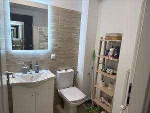 a bathroom with a toilet and a sink and a mirror at Cely's Ap Class Park in Târgovişte