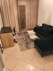a living room with a couch and a table at Flat30 - Cosy apartment in Park of Kipseli- Xanthi in Xanthi