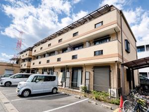 a van parked in a parking lot in front of a building at Karawaru Stay 浦安 B303 Disney 9min in Tokyo