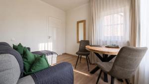 a living room with a table and a couch at 'tNest Middelaar in Middelaar