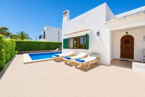 a villa with a swimming pool and a patio at Villa Binimelis in Cacla D'or