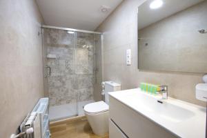 a bathroom with a toilet and a sink and a shower at Balcón de los Herreros in Cuenca +16 photos