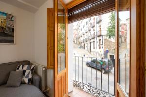 a room with a balcony with a view of a car at Balcón de los Herreros in Cuenca