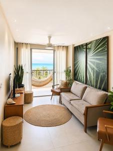 a living room with a couch and a view of the ocean at Ap centro de Guarapari com as melhores vistas!!! in Guarapari