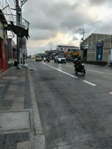 a person riding a motorcycle down a city street at hotel habiby32 descansa in Barranquilla