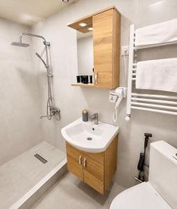 a bathroom with a sink and a toilet and a shower at Vernisa Hotel in Tbilisi City +63 photos