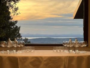 a table with wine glasses on it with a view at Annina Locanda in Corciano