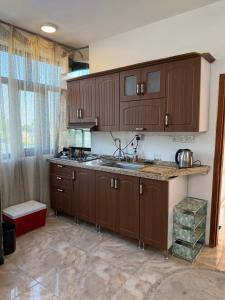 a kitchen with wooden cabinets and a counter top at شركة دار المعرفة للعقار in Baghdād
