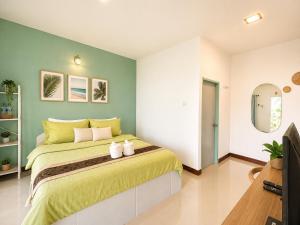 a bedroom with a large bed with two towels at Ava Beach Pakbara in Ban Pak Ba Ra +17 photos