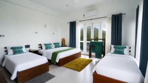 a bedroom with two beds and a window at Golden Sky Hotel & Wellness in Kandy