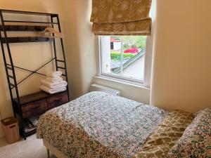 a bedroom with a bed and a window at Myrtlebank in Pitlochry