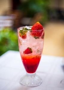a drink with a strawberry in a glass at Sandton hotel kasese in Nalakonge