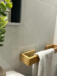 a bathroom with a wooden towel holder and a mirror at Hostal Rural Sositana in Castejón de Sos +75 photos