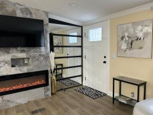 a living room with a fireplace and a flat screen tv at Loeras Inn in Dumfries