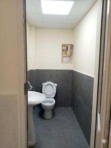 a bathroom with a toilet and a sink at HUSAYN HoSTEL in Xirdalan