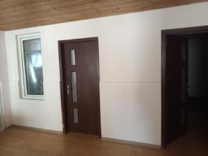 an empty room with two doors and a window at HUSAYN HoSTEL in Xirdalan