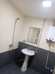 a bathroom with a sink and a mirror at HUSAYN HoSTEL in Xirdalan