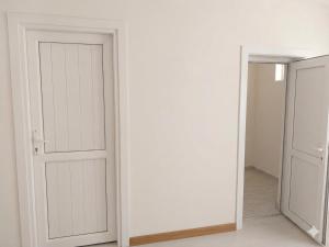 an empty room with a door and a hallway at HUSAYN HoSTEL in Xirdalan