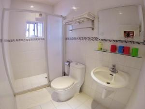 a white bathroom with a toilet and a sink at I WoW in Xiaoliuqiu