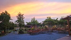 a group of tables and benches with a rainbow in the sky at Haus im Herrengrund in Schollbrunn +25 photos
