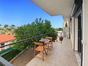 a balcony with a table and chairs on it at Mermaid Beach in Roquebrune-Cap-Martin